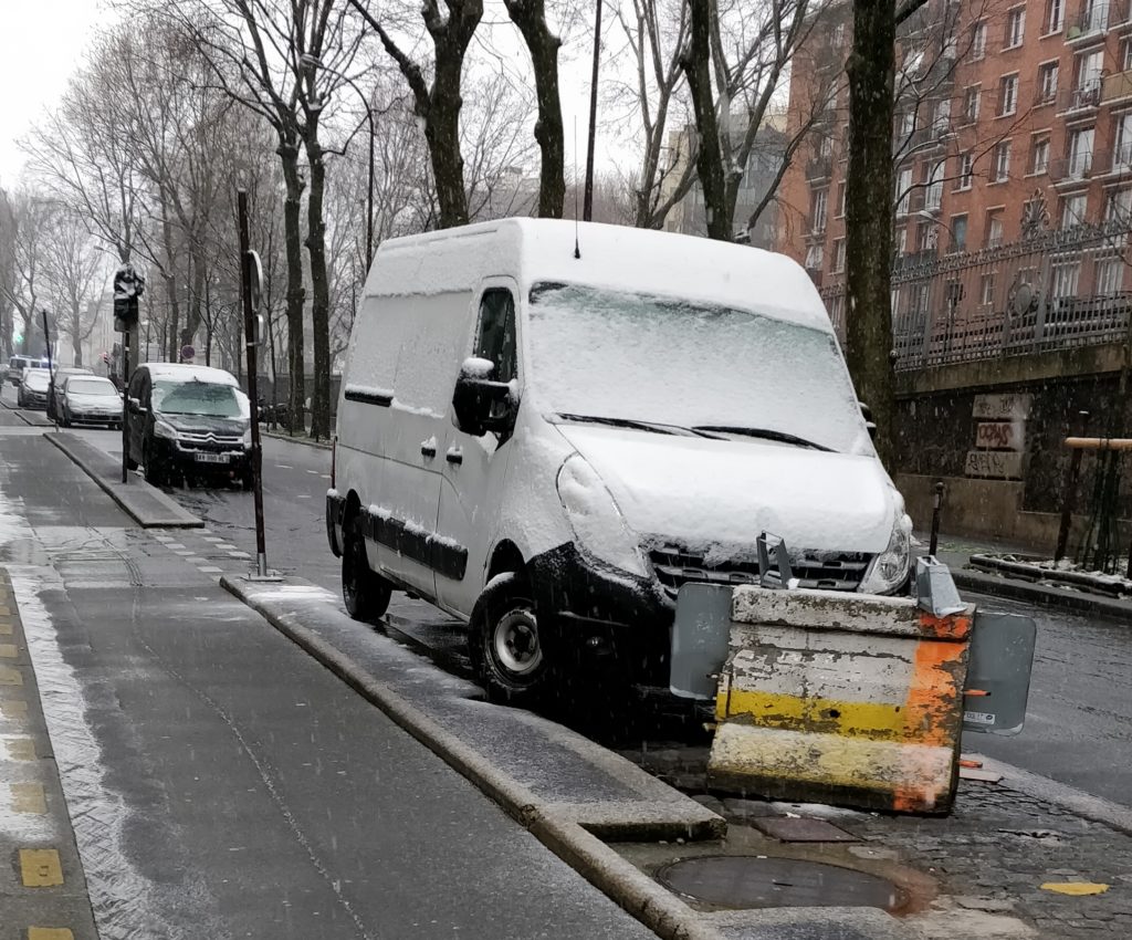 Car covered with snow in paris